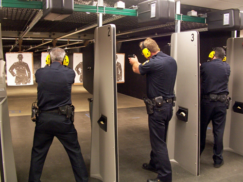 Three law enforcement officers pictured in close target range training