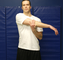 Image of man stretching his right arm across the front of his chest